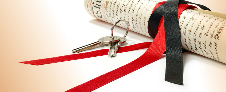 Legal Documents tied with red ribbon and keys to a property